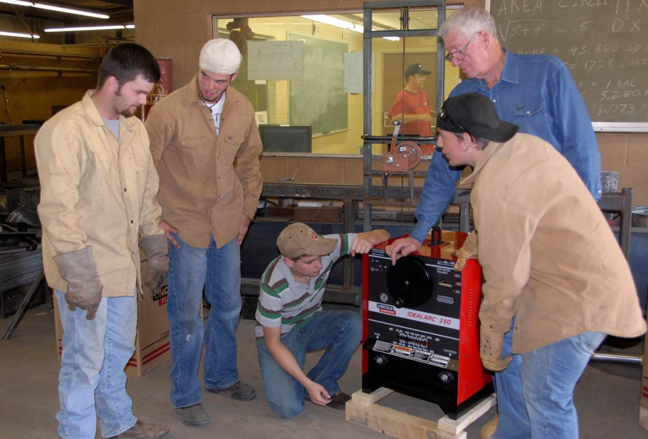 men working around a welding machine