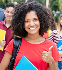 African american teen in red shirt smiling, showing thumbs-up