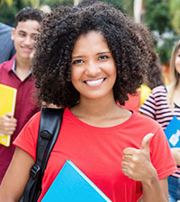 smiling young woman gesturing thumbs-up