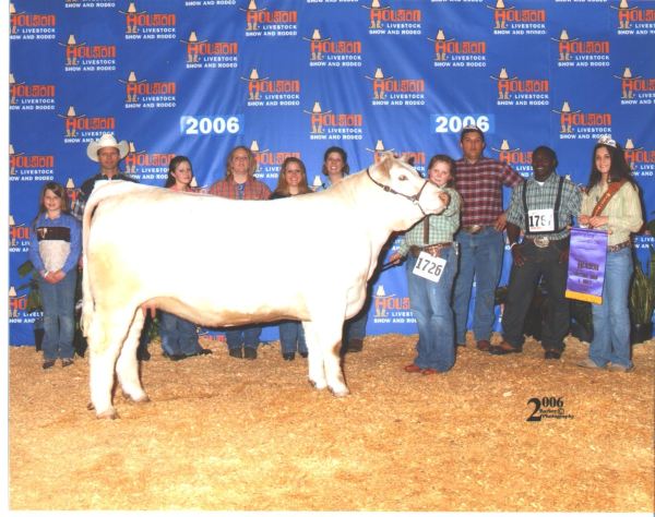 Ag team on stage with prize heifer