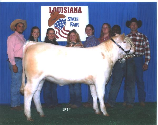 Ag team on Louisiana State Fair stage with prize bull