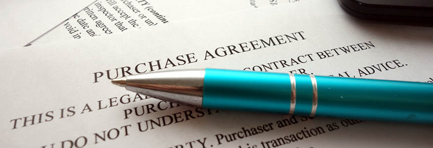 Purchase agreement document for filling and signing on desk