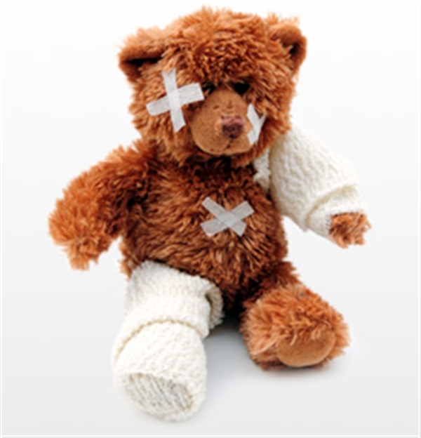 Stuffed bear wearing bandanges                                                                                                              
