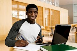 Man at computer desk working on homework. 