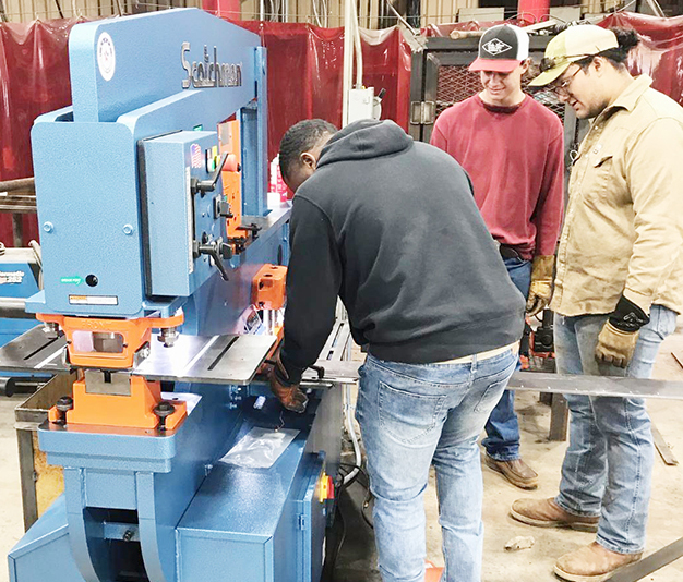 Students using the new Iron Worker machine are Cameron Spurlock and Abner Ramirez from Palestine and Clayton Culligan from Okeechobee, Florida.