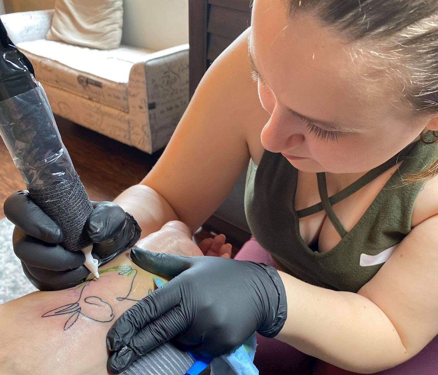 Katie Harris - Tattooing a client                                                                                                           