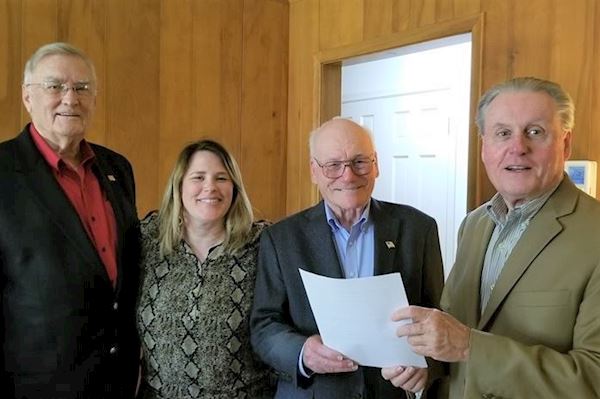 Ray Raymond, TVCC Board of Trustees Chairman, Kristen Bennett, Ed.D, TVCC Vice President for Institutional Advancement and Executive Director of the Foundation, Arlton White, and Jerry King, Ed.D., TVCC President, with deed to the donated piece of property and closing documents.