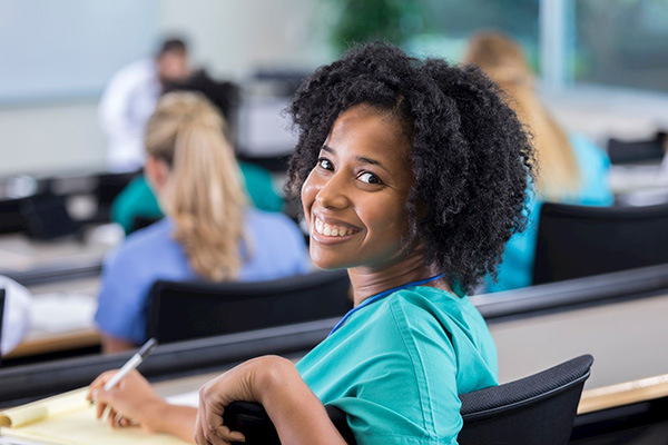 Attractive black girl smiling in classroom.