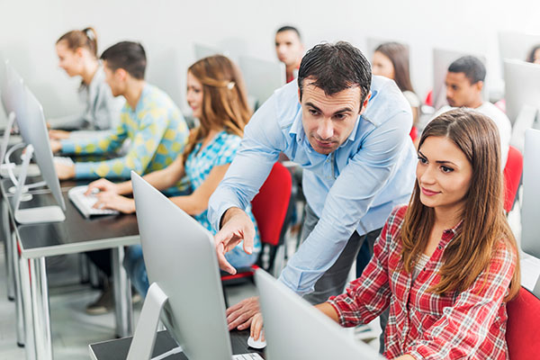 instructor helping student in computer lab