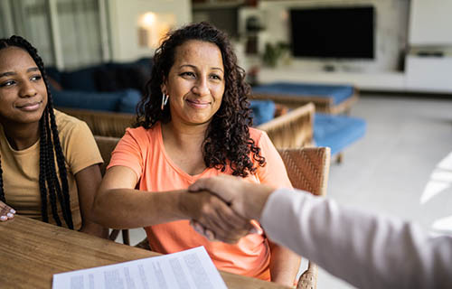 Professional consultant handshake with customer during a home visit