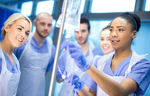 nursing students working with IV package