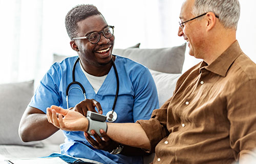 male nurse taking patient blood pressure