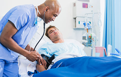 male nurse taking patient blood pressure