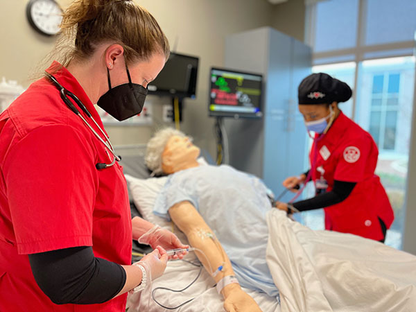 nursing students learning on a mannequin