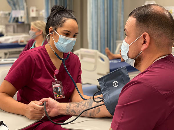 nursing students practicing taking blood pressure