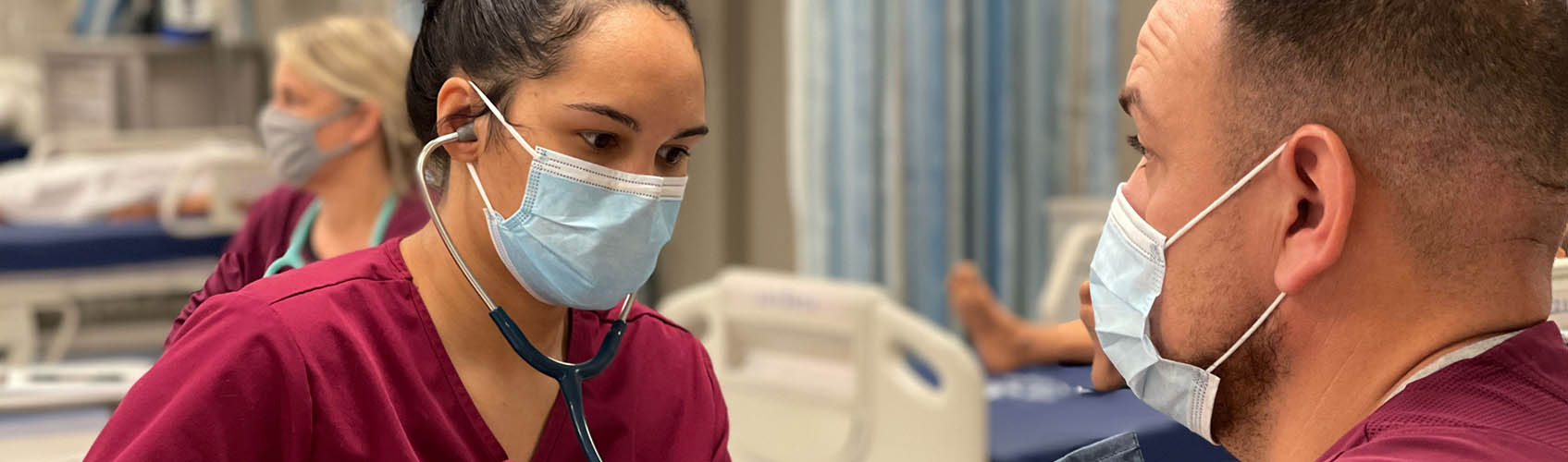 Woman nursing student working on simulated patient