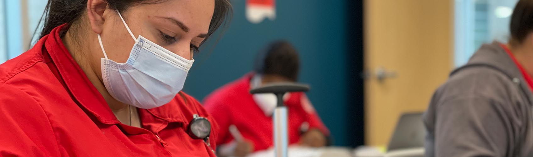 Woman nursing student working on simulated patient