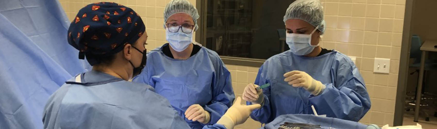 Woman nursing student working on simulated patient