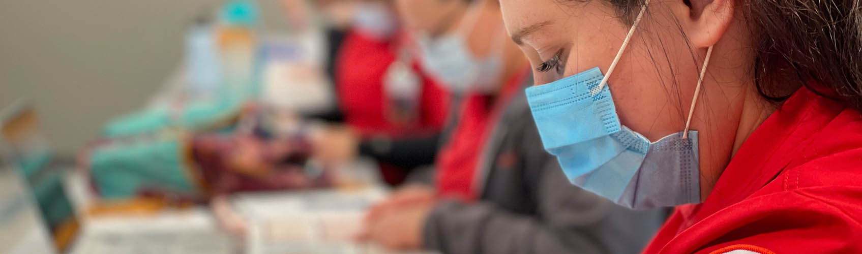 Woman nursing student working on simulated patient