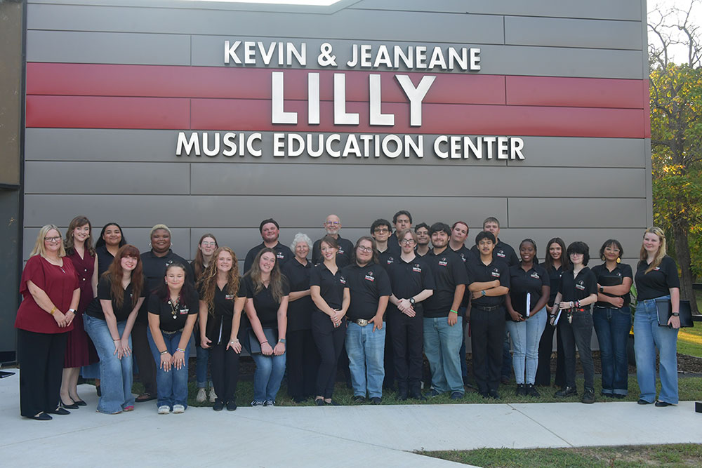 TVCC choir standing outside the Kevin & Jeaneane Lilly Music Education Center