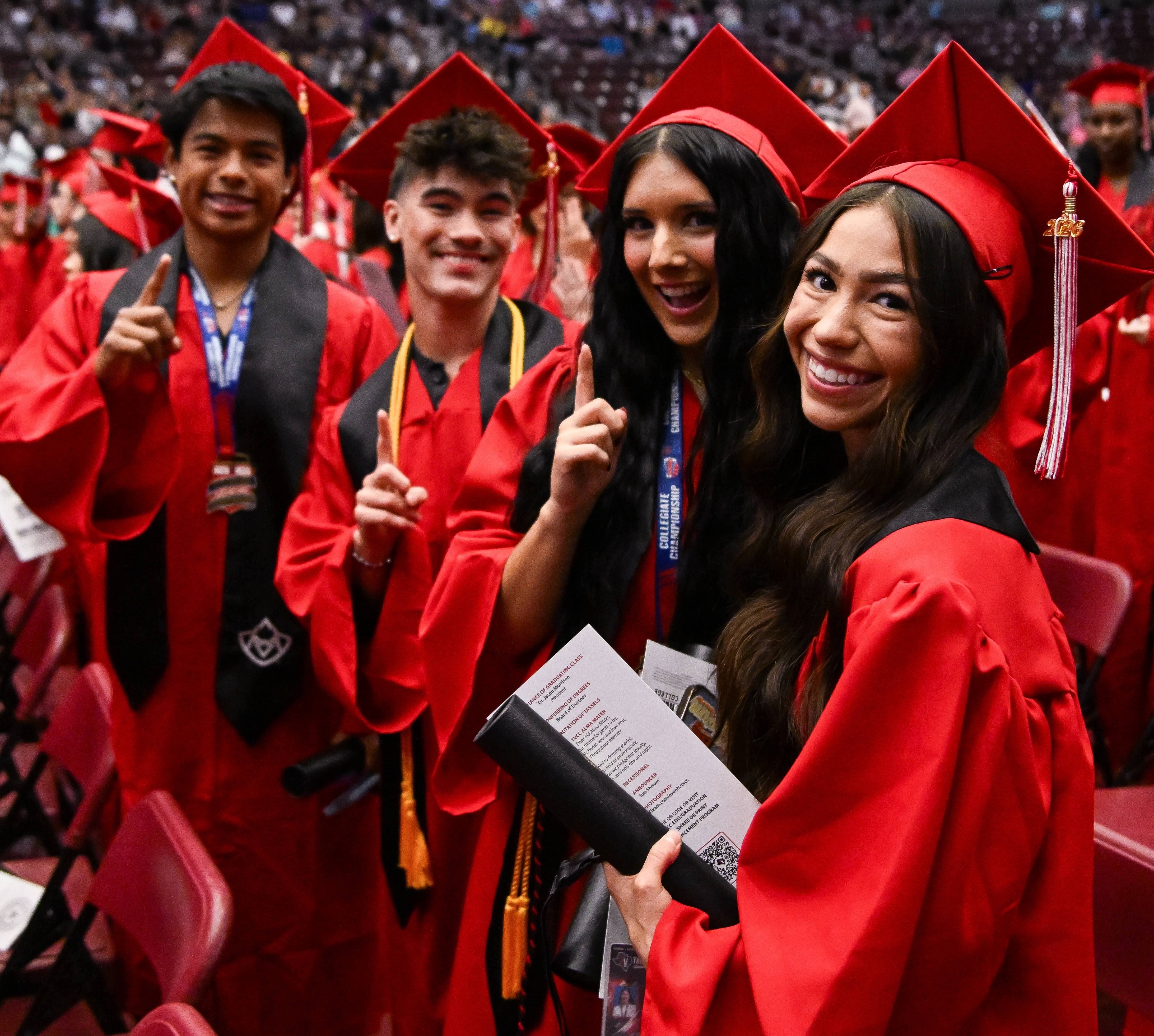 TVCC Graduates pose for photo in their caps and gowns. 