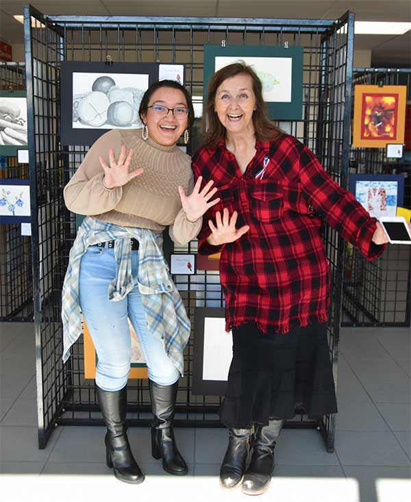 September Kirk with an art student at an art show