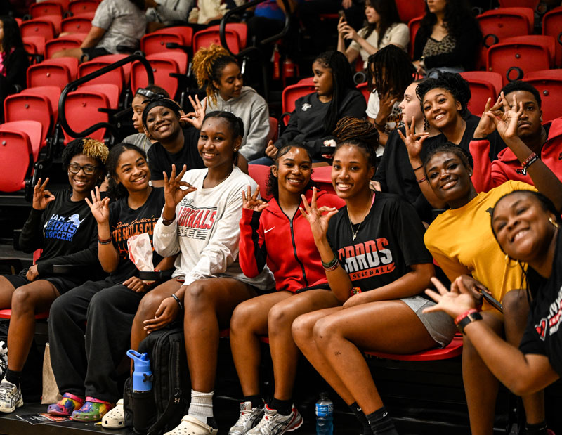 a group of tvcc students sitting in the stands to watch a game