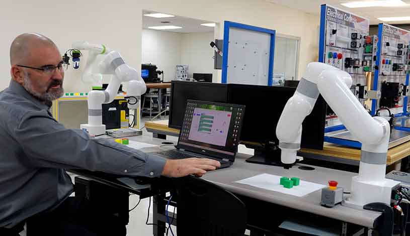 instructor interacting with the automation controls robot