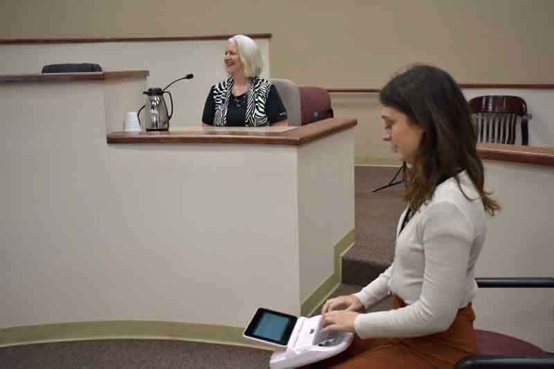 Scopist typing what a witness is testifying