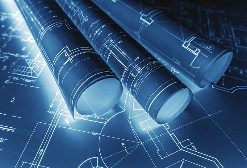 Blueprints rolled up on a table
