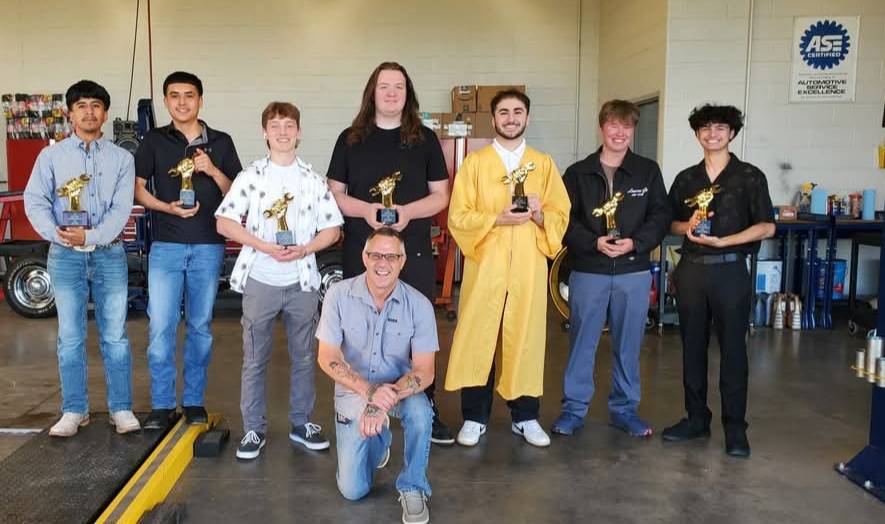 Dual Credit students in the automotive program holding trophies