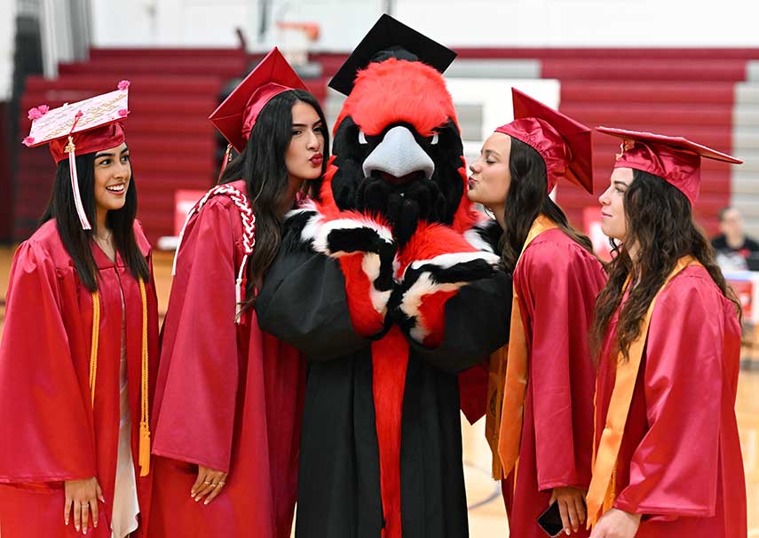 Graduates posing with Reggie in the middle.