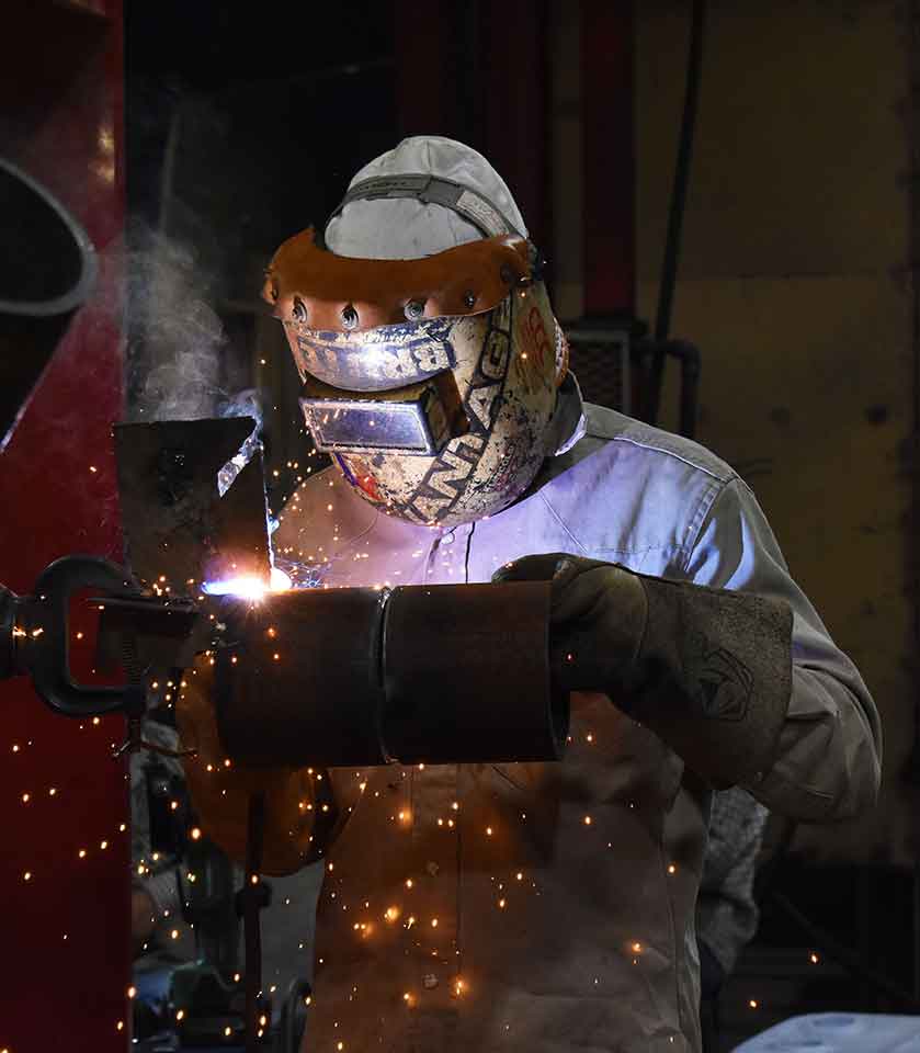 instructor welding a pipe
