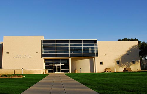 large brick building with green lawn